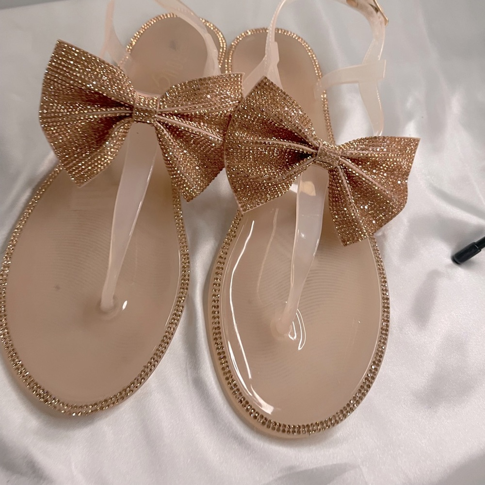 Rose gold thong sandals with rhinestone rose gold bows.